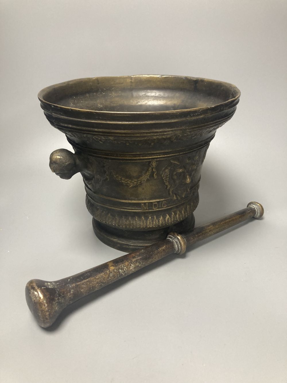 A large bronze mortar and pestle, bearing mock date 1630, 25cm diameter, and two iron and brass canon models